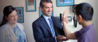 Dr. Christopher Ahmad examines a patient